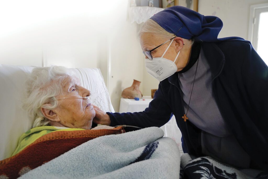 A nun speaking with a family.