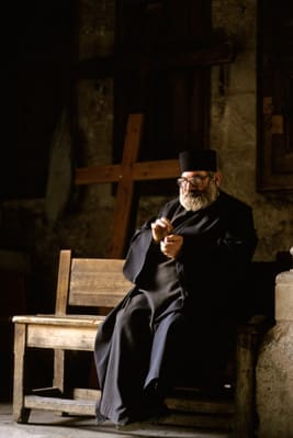 In the Church of the Holy Sepulchre, an Orthodox priest pauses to pray during Holy Week. (photo: Paul Souders)