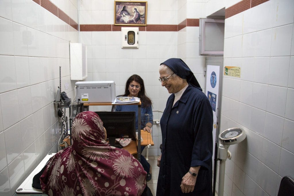 Sister Simone visits a patient at the dispensary.
