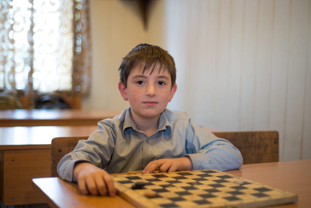 a child plays checkers at the Harmony Day Center in Georgia.