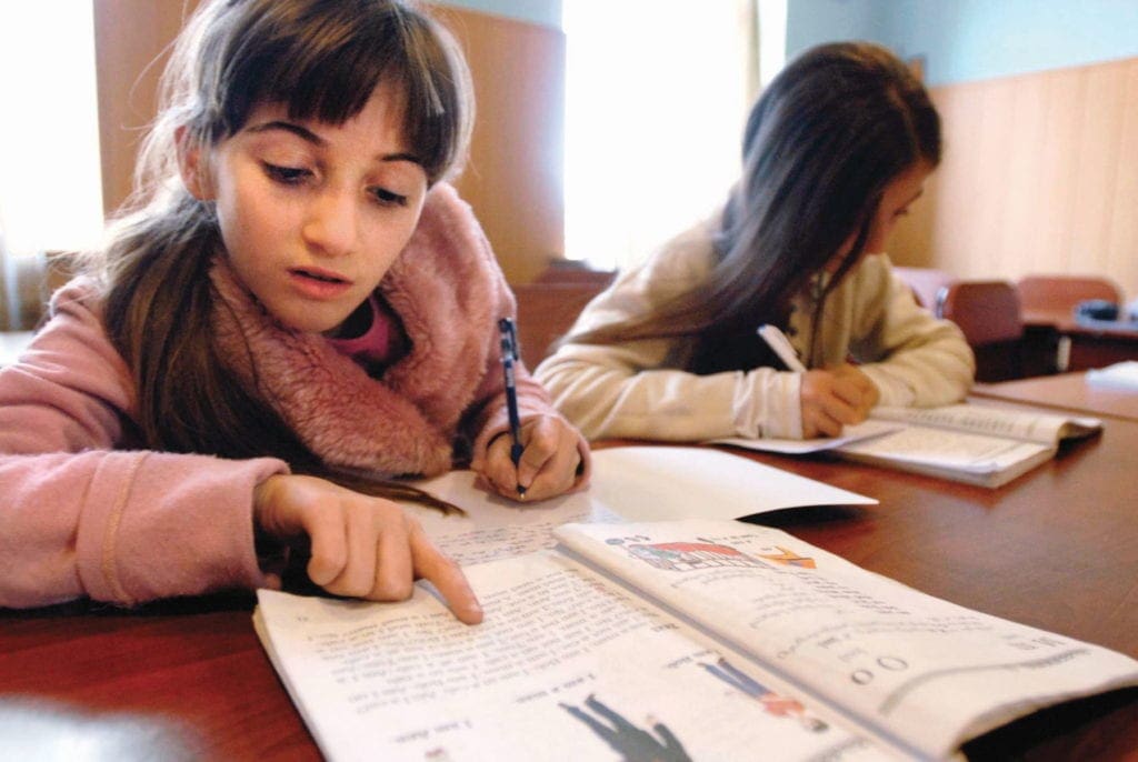 girls study at a large table in the eastern european nation of Georgia.