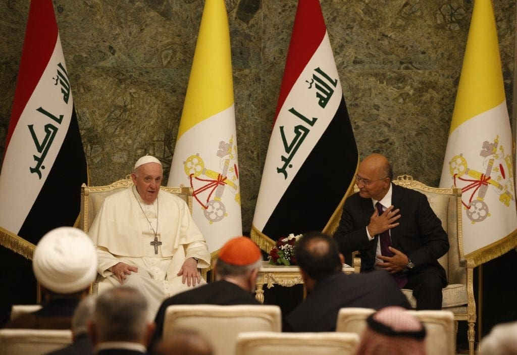 Pope Francis and Iraqi President Barham Salih attend a meeting in the hall of the presidential palace in Baghdad