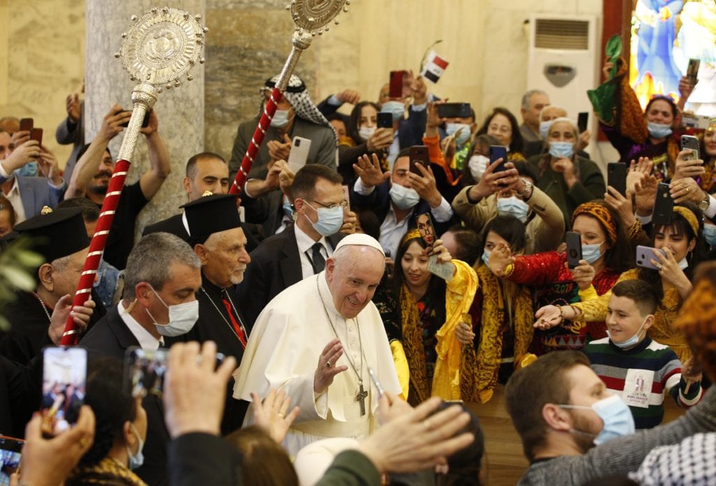 Pope Francis is greeted by a crowd of enthusiastic faithful at the Church of the Immaculate Conception in Qaraqosh, Iraq
