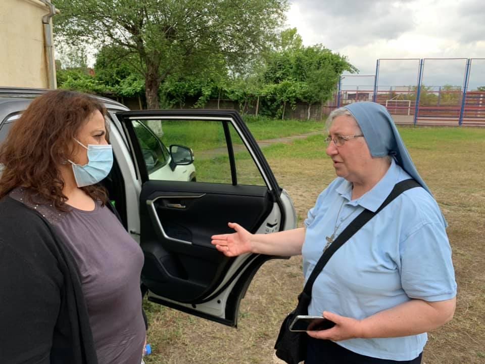 Anahit Mkhoyan (left), executive director of Caritas Georgia, speaks with Sister Loredana Monetti, who operates the Caritas programs in Kutaisi.