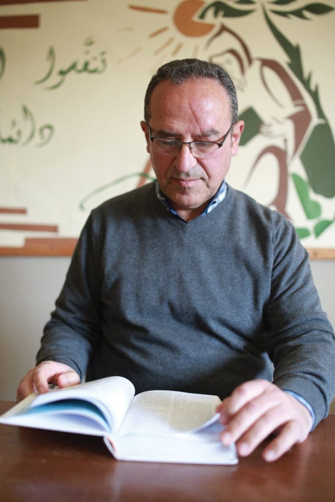 a photo of Pierre Habib reading a book.