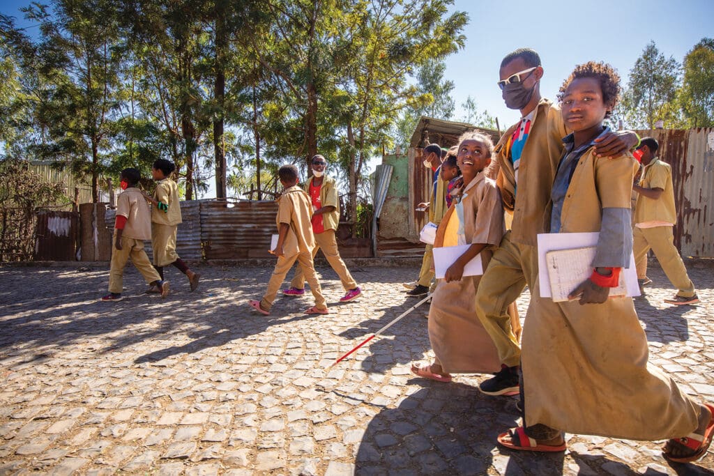 Students in uniform walking.