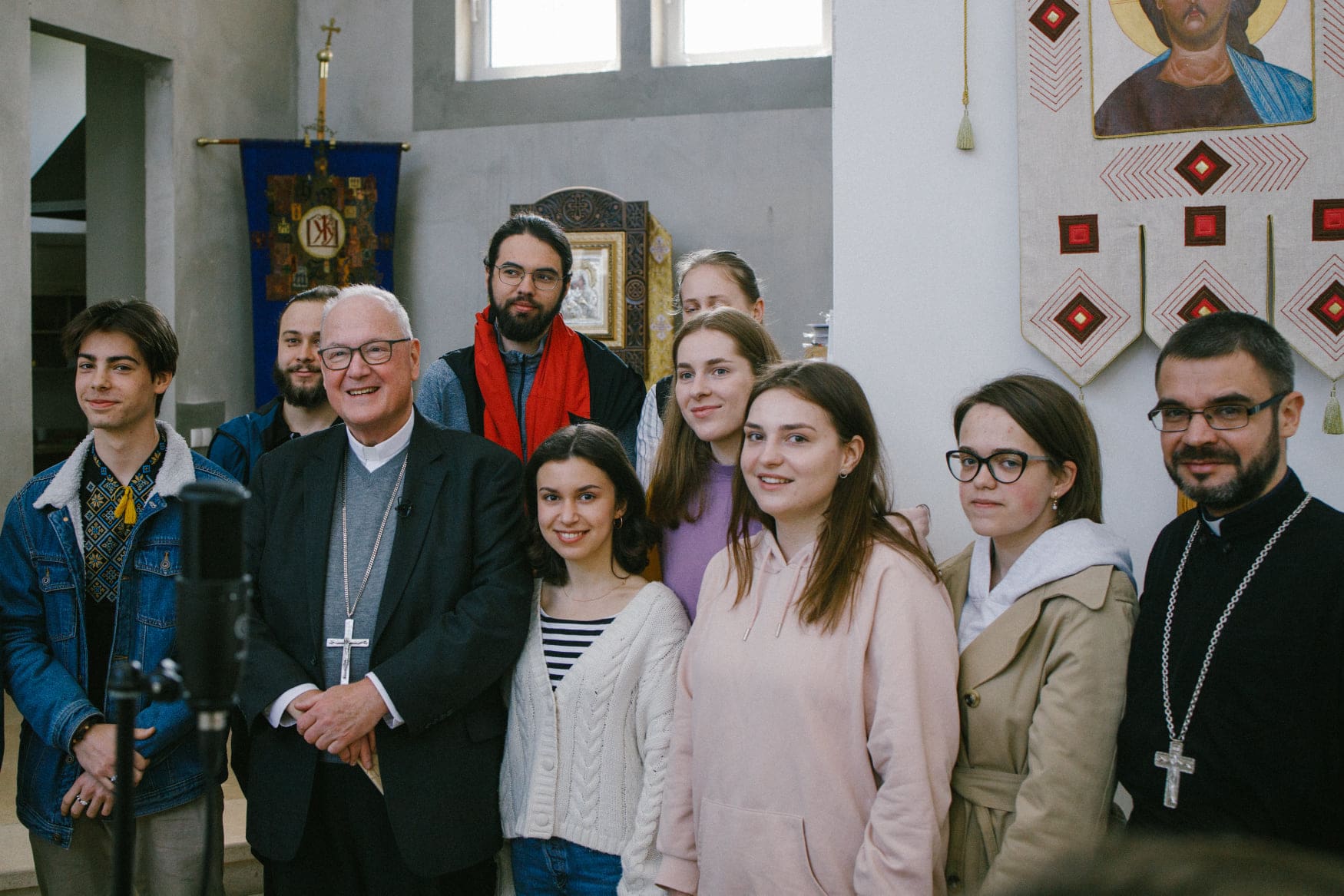 Cardinal Timothy Dolan poses for a photo with students at the chapel of Ukrainian Catholic University in Lviv on 1 May.