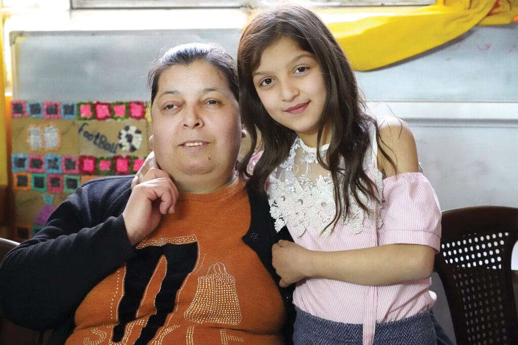 Rachelle Naser and her blind mother, Raghida, participate in the Family Support Project in Dwel’a, Syria, where Rachelle says she learned to care for her mom