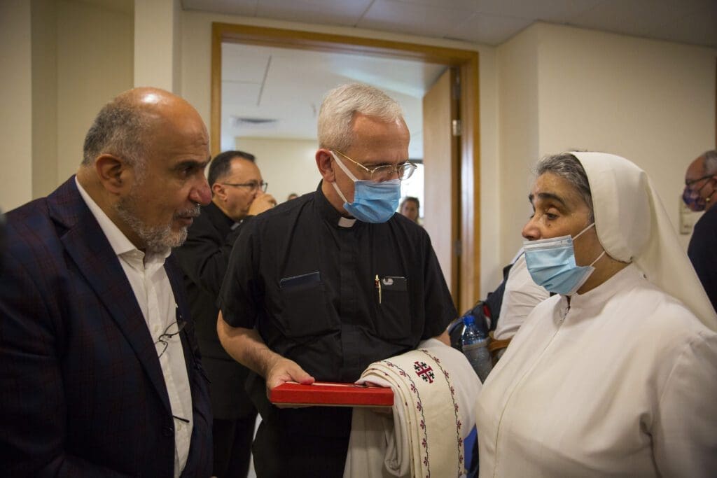 Priest talks to a Religious Sister at the Rosary Sisters Hospital in Lebanon.