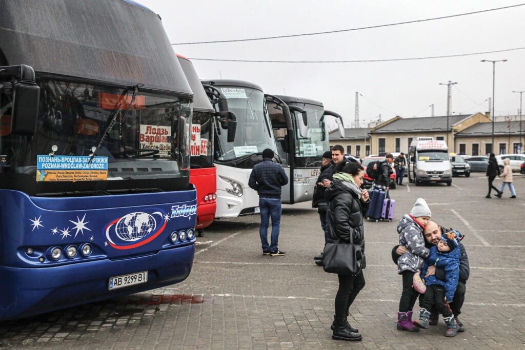 Children bid their father farewell at a train station in Lviv in January.