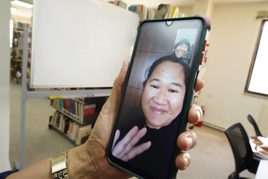 Migrant worker in Jordan using video chat apps to stay in touch with their support network.