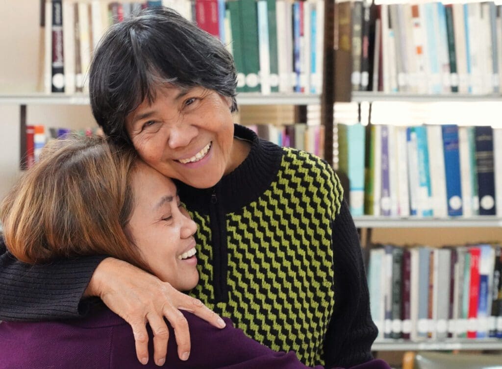 A migrant worker Alma Mutuc hugs Elisa Estrada, a member of the Teresian Association in Amman.