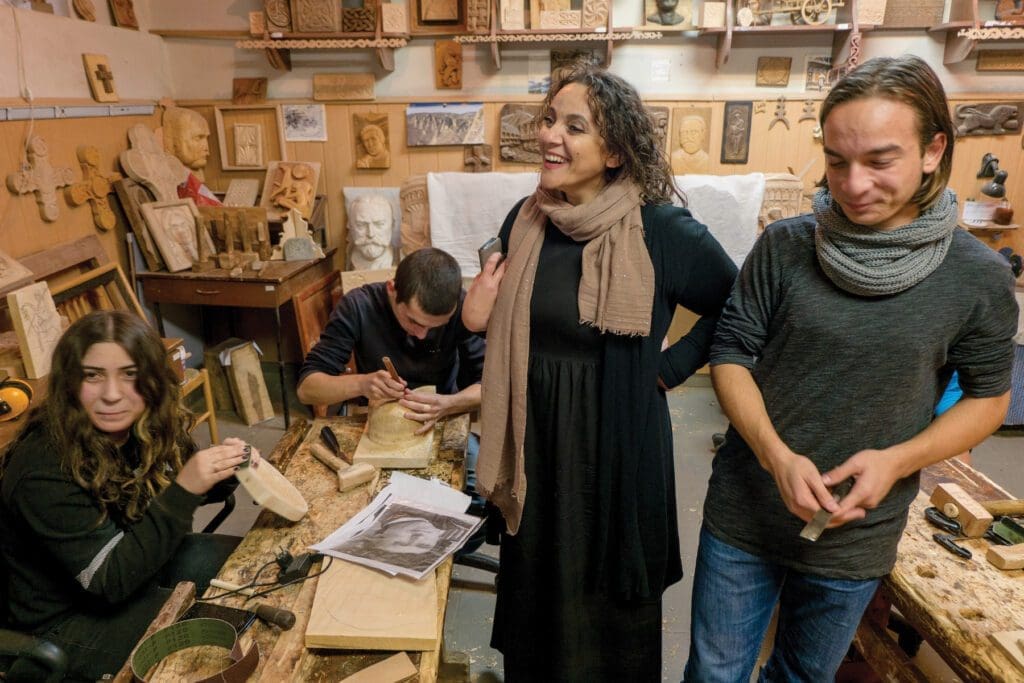 Young adults learn woodworking at a workshop in Tblisi, Georgia.
