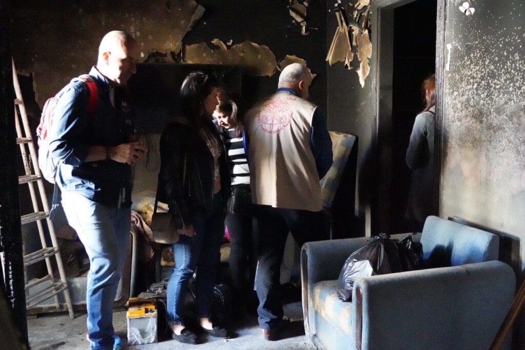 The staff of CNEWA visit an apartment damaged by the earthquake in Aleppo.