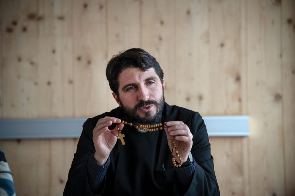 Priest holding a rosary.