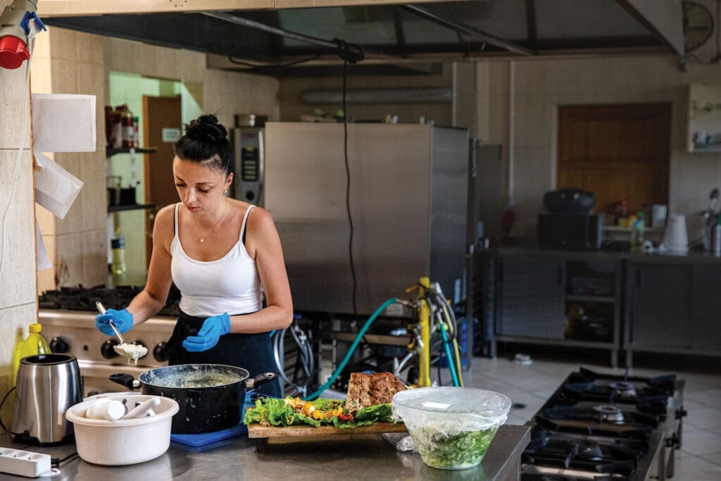 A woman cooking in a large kitchen in Poland.