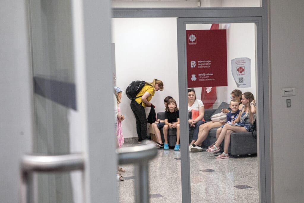 Ukrainian refugees wait to meet with Caritas Poland staff in Warsaw.