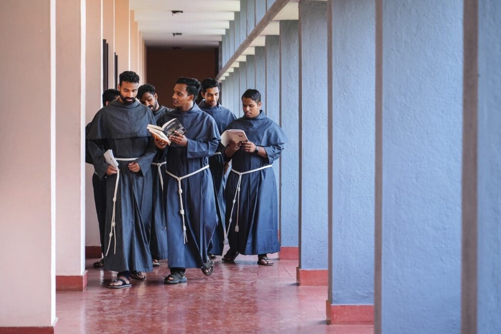 Five Franciscan seminarians walk at Kolbe Ashram Seminary.