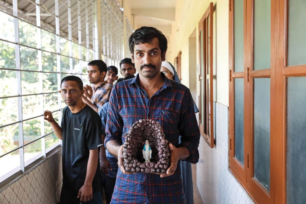 Student Nixon Jose holding statue of the Virgin Mary. The Samaritan Sisters in Thrissur, Kerala, provide housing, care, community and vocational training for 55 people with intellectual challenges at their residential school, Snehadeepthy, since 2000.