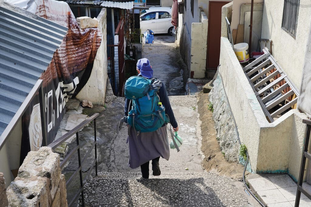 Sister Cecilia makes her way through Dbayeh camp on her home visits with a backpack full of medication and other supplies