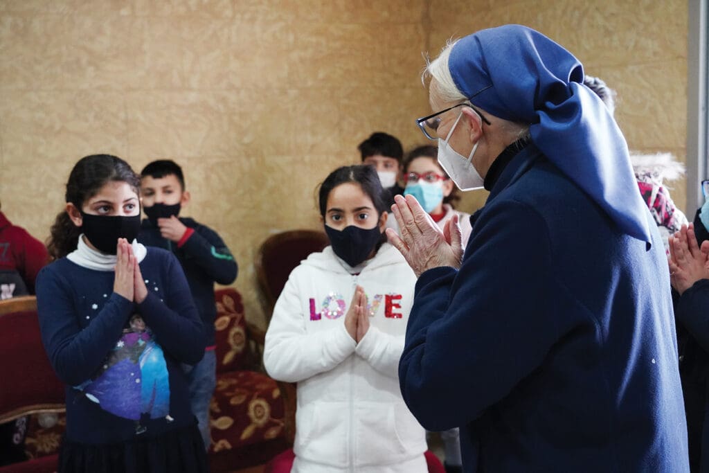 Sister Magdalena gives a catechism class to the children of the camp, who are preparing for first Communion