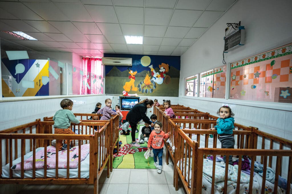 A nursery with cribs and infantes in them.